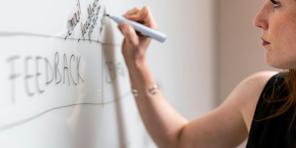 A person drawing on a whiteboard, symbolizing the lessons in plot structure found in Goosebumps' twist endings.