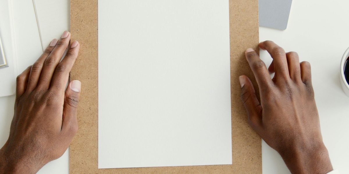 A person looking frustrated, staring at a blank page, embodying the challenge of writer's block.