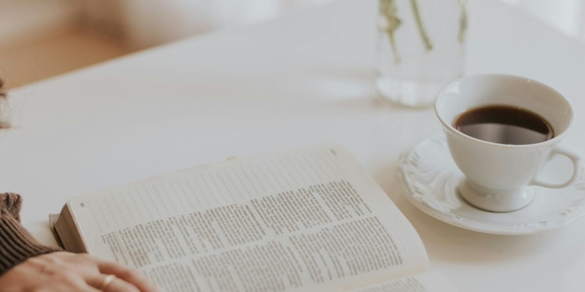 A reader deeply engrossed in a book, reflecting the anticipation for Donna Tartt's next release.
