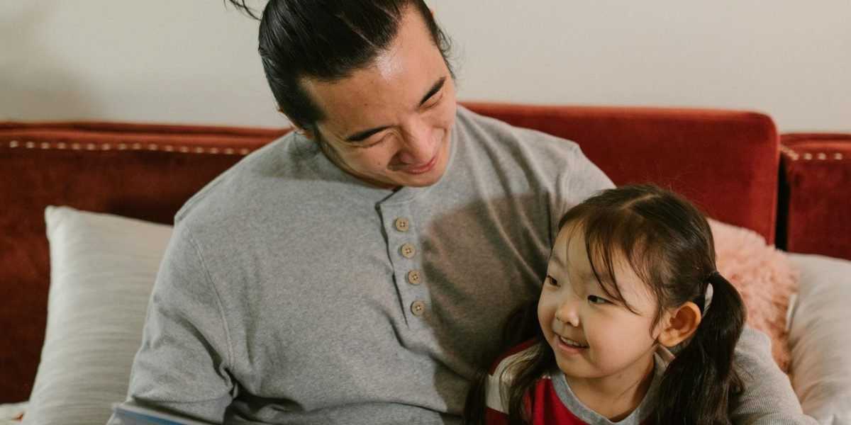 A parent sharing the joy of a fantasy story with a child, highlighting accessibility for new readers.
