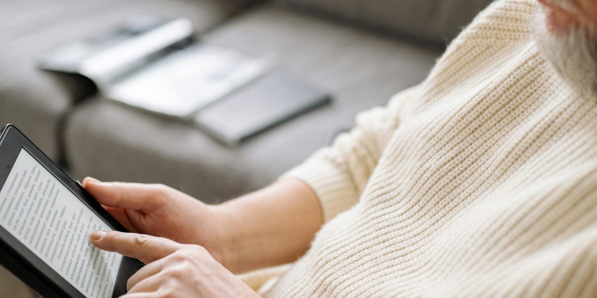 Relaxing and enjoying a good book on an e-reader, a common scene for modern readers accessing digital libraries.