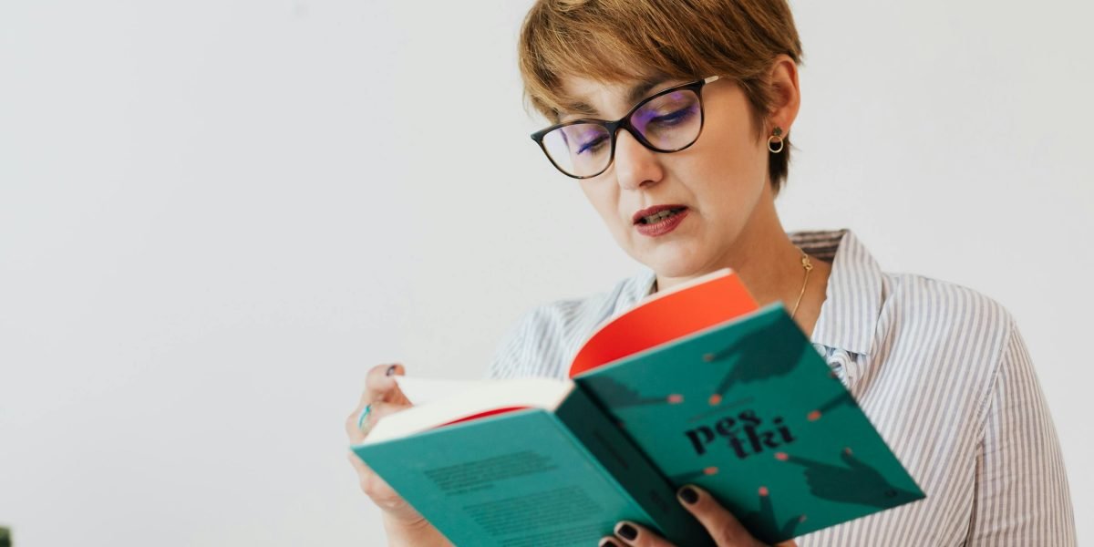 A person immersed in reading a timeless classic novel, reflecting Dumas's enduring appeal.