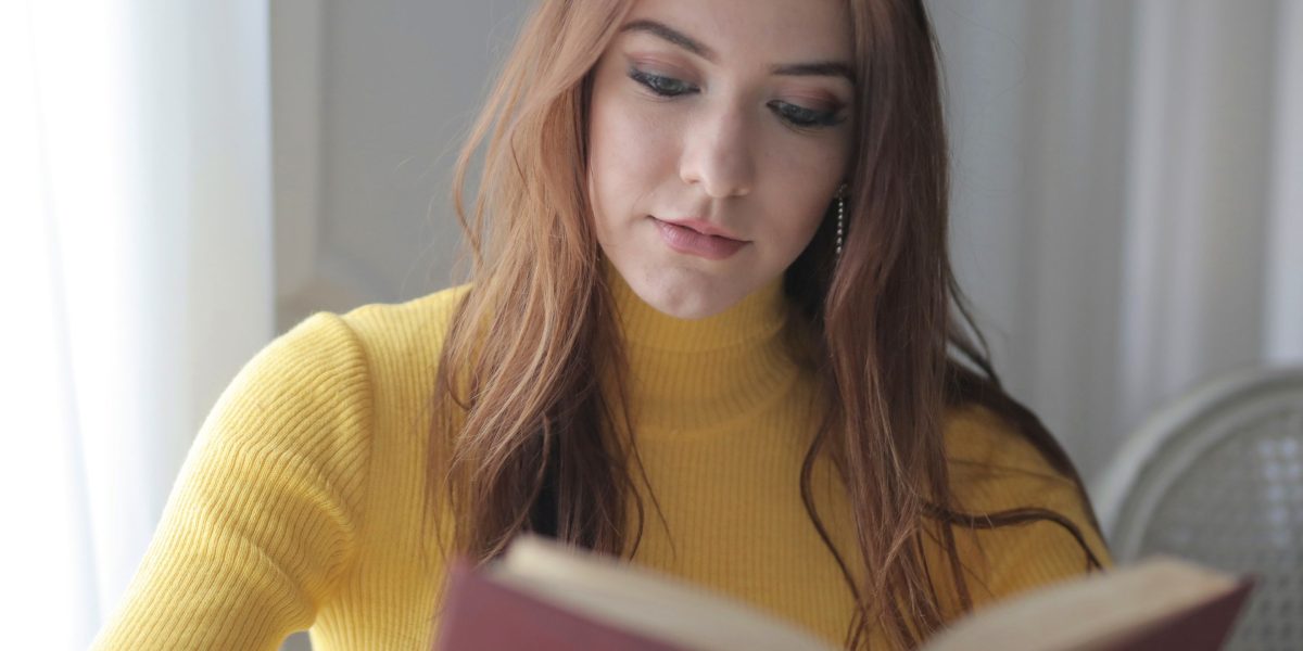 A person absorbed in reading a book, reflecting deep thought and engagement.