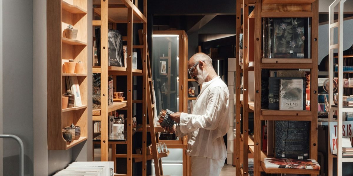 A person thoughtfully browsing shelves, embodying the challenge and joy of discovering a new science fiction book.
